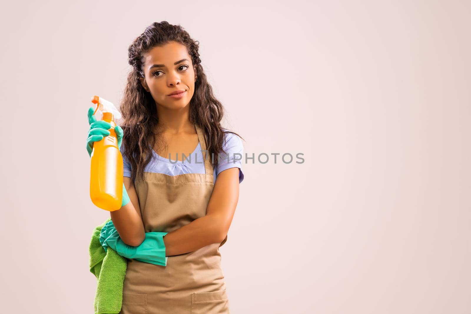 Portrait of african-american professional maid who is tired of cleaning.