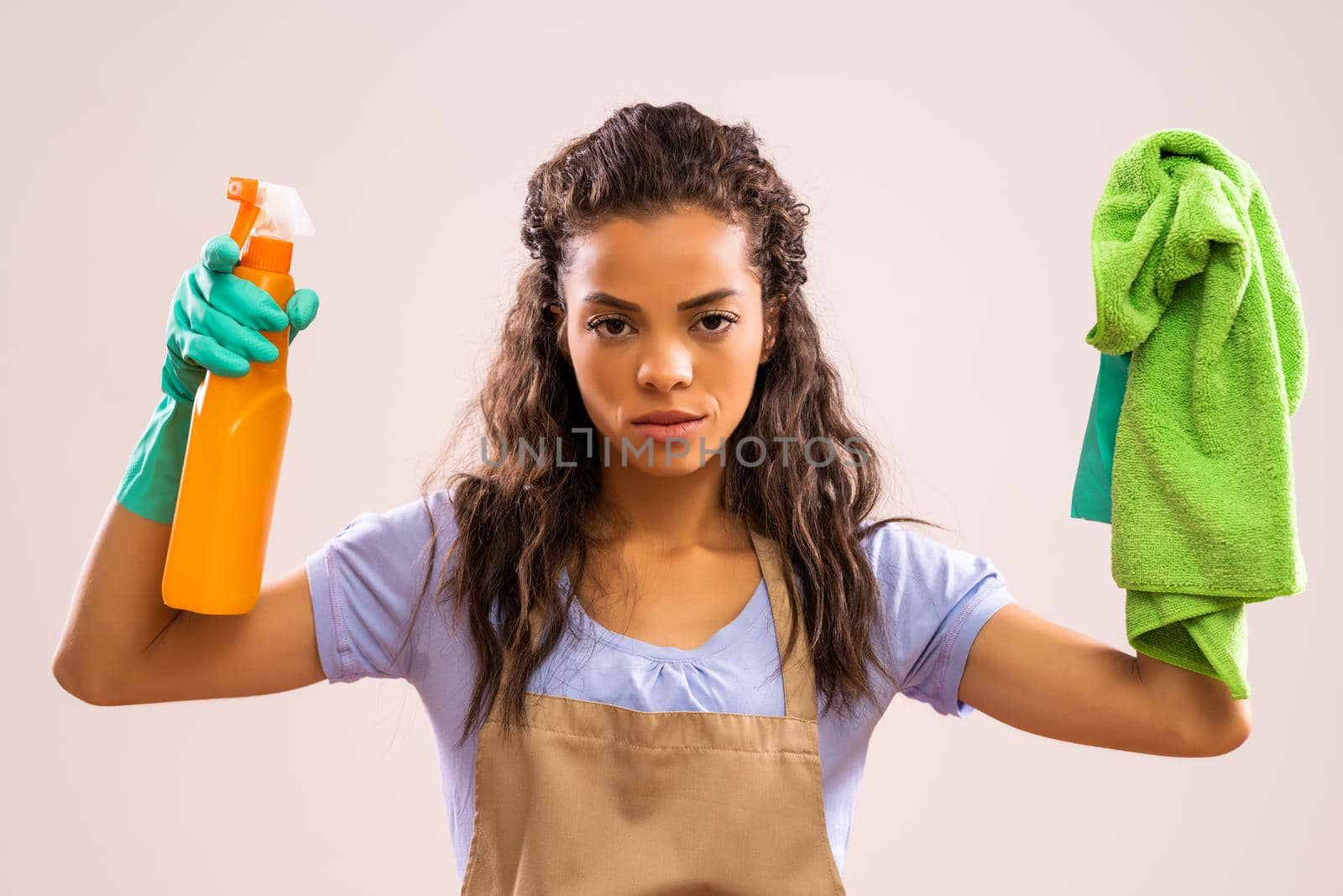 Portrait of african-american professional maid who is tired of cleaning.