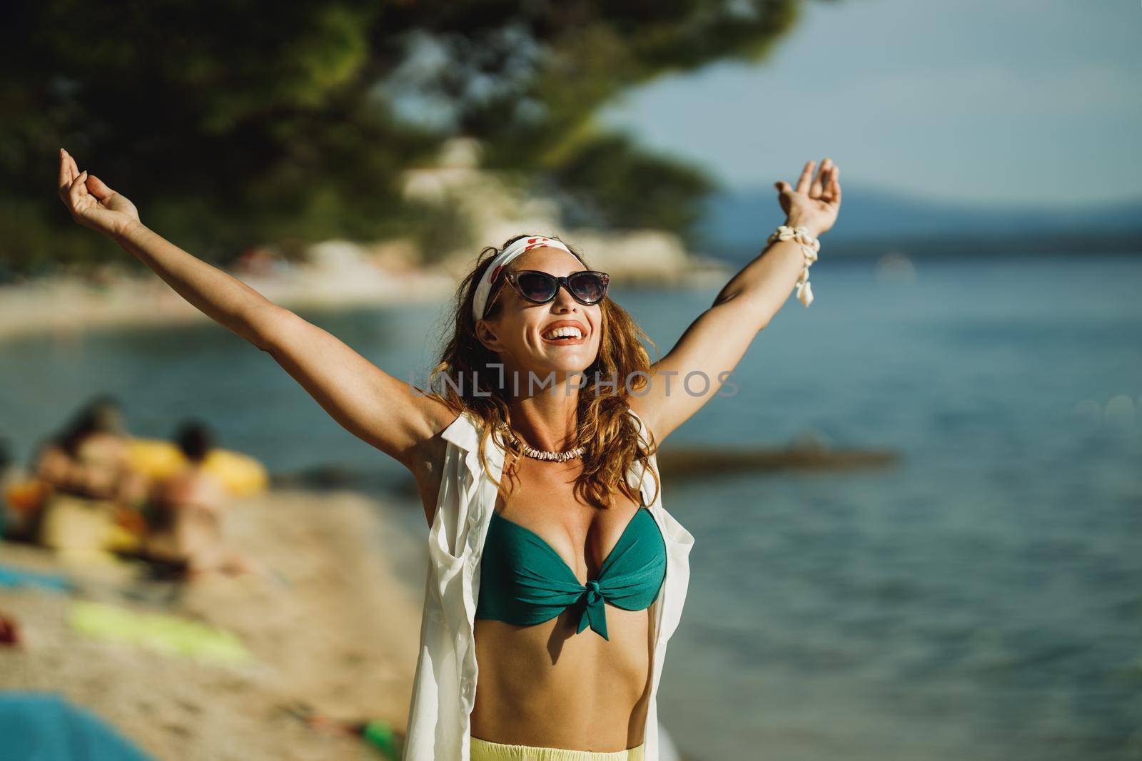 An attractive young woman in bikini is having fun on the beach and enjoying a summer vacation.
