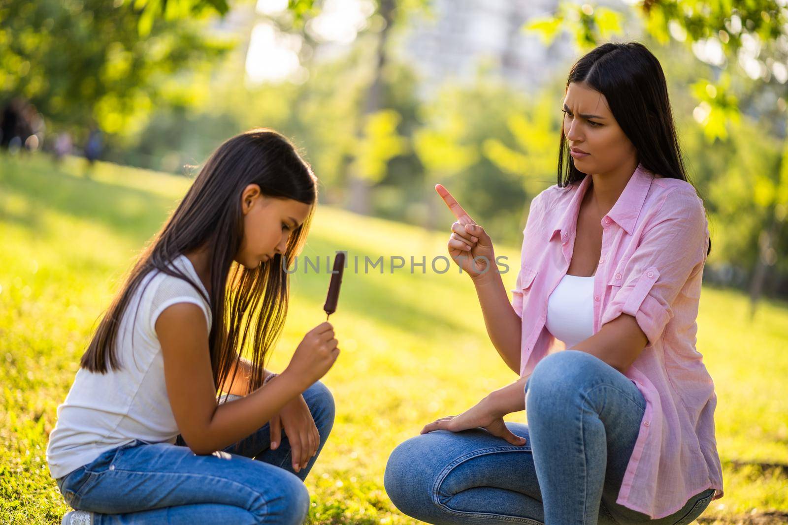 Mother is angry because her daughter is eating too much ice cream.