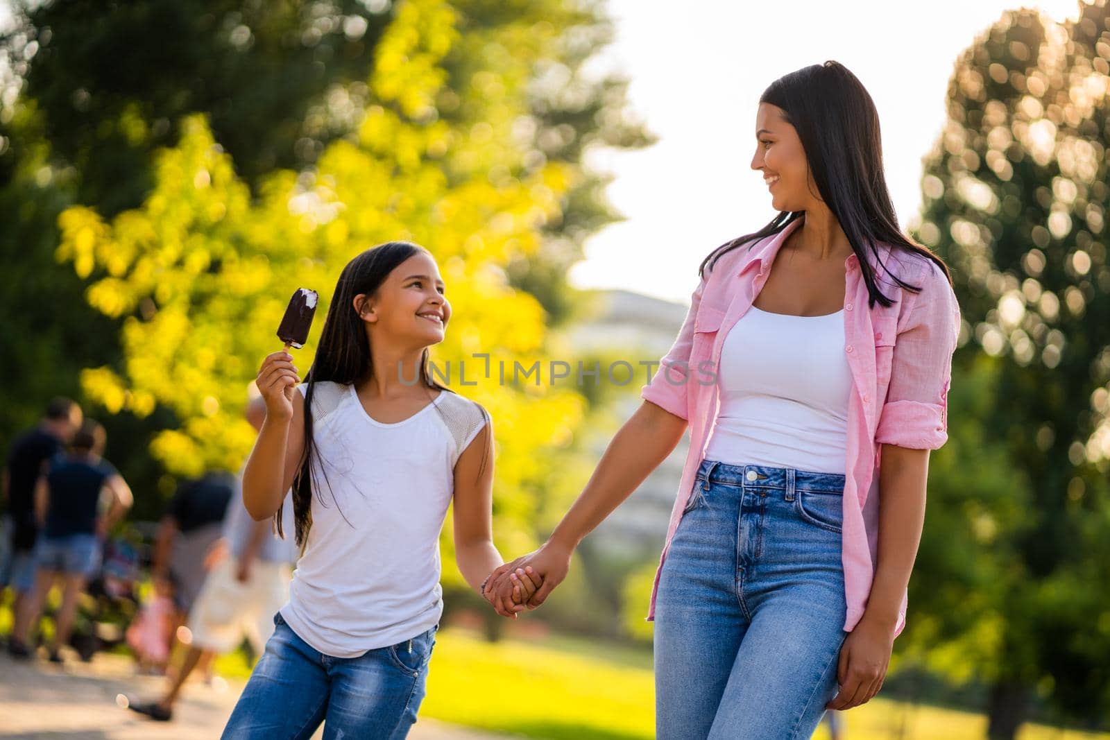 Happy family having nice time in park together.