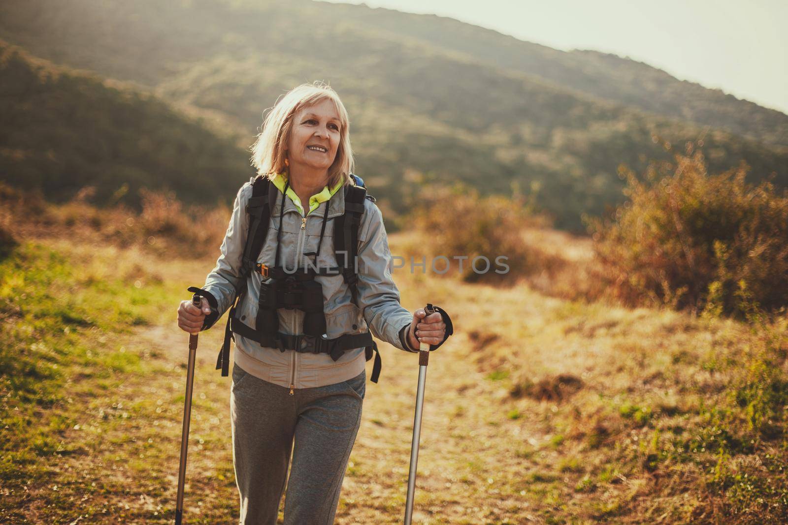Senior woman is hiking in mountain. Active retirement.