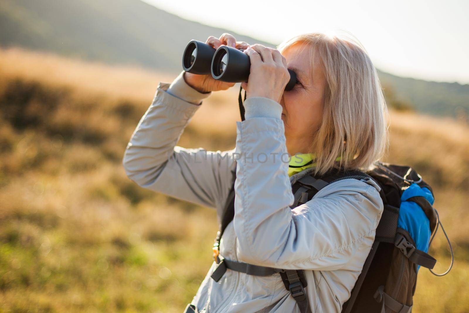 Senior woman is hiking in mountain. Active retirement.