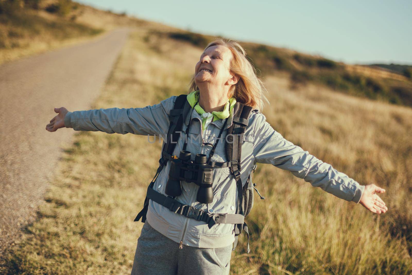 Senior woman is hiking in mountain. Active retirement.