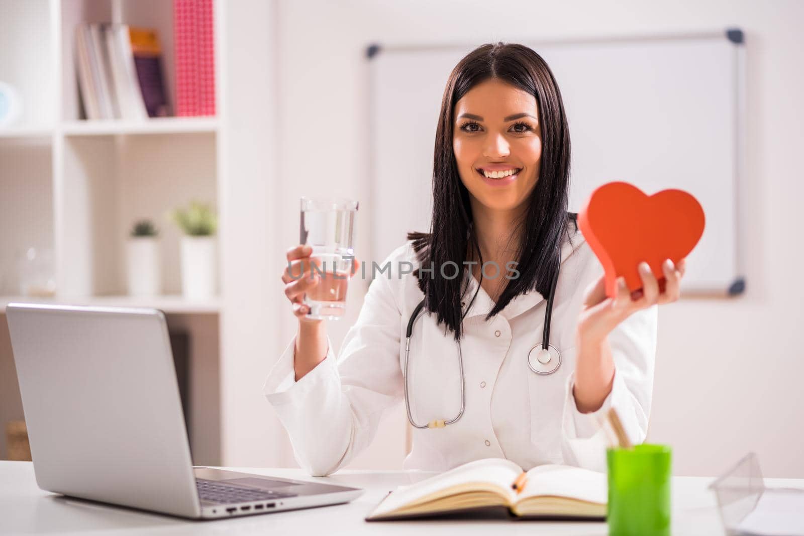 Young doctor in her office talking about heart health.