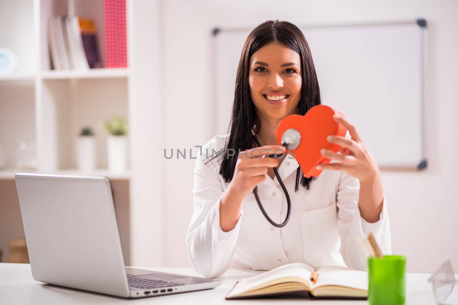Young doctor in her office talking about heart health.