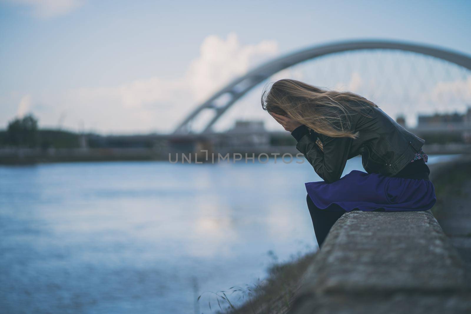 Lonely and depressed woman sitting in grief.