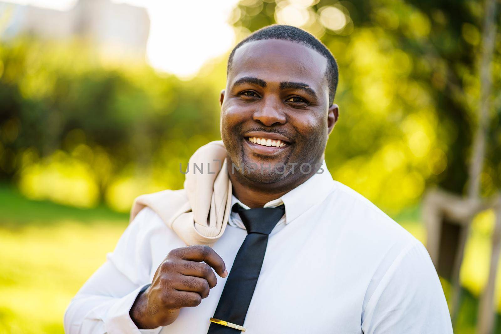 Portrait of happy african-american businessman who is looking at camera and smiling.