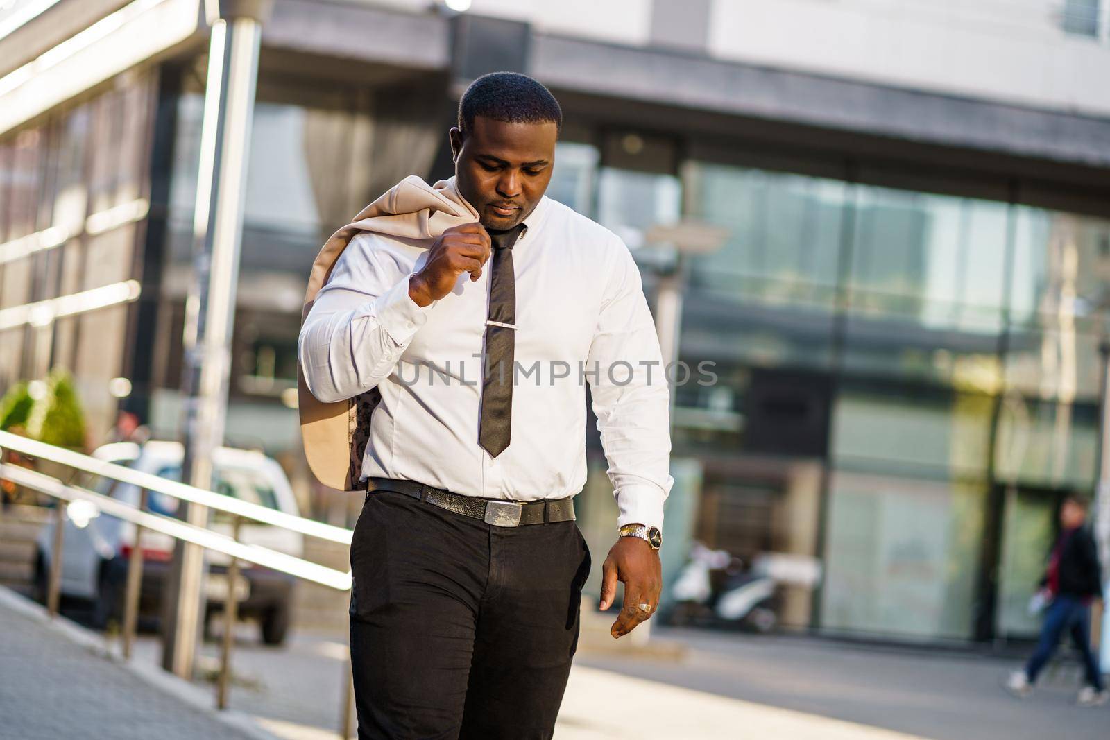 Portrait of tired african-american businessman who is going home from work.
