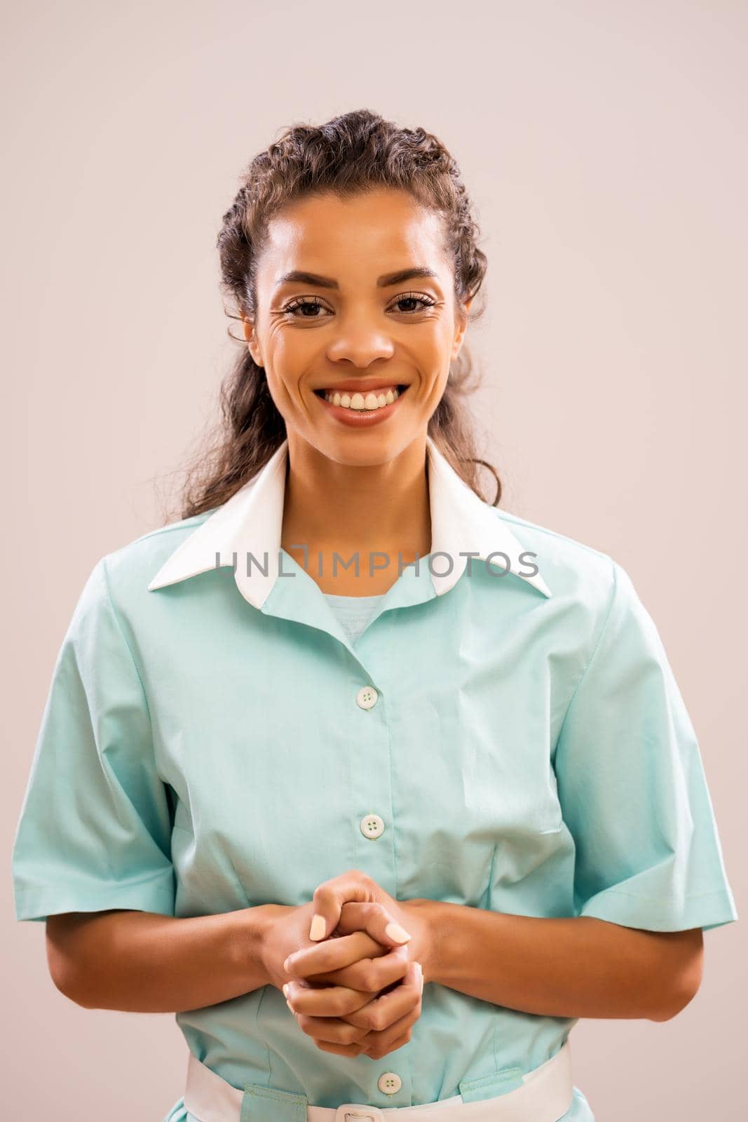 Portrait of young happy nurse who is looking at camera and smiling.