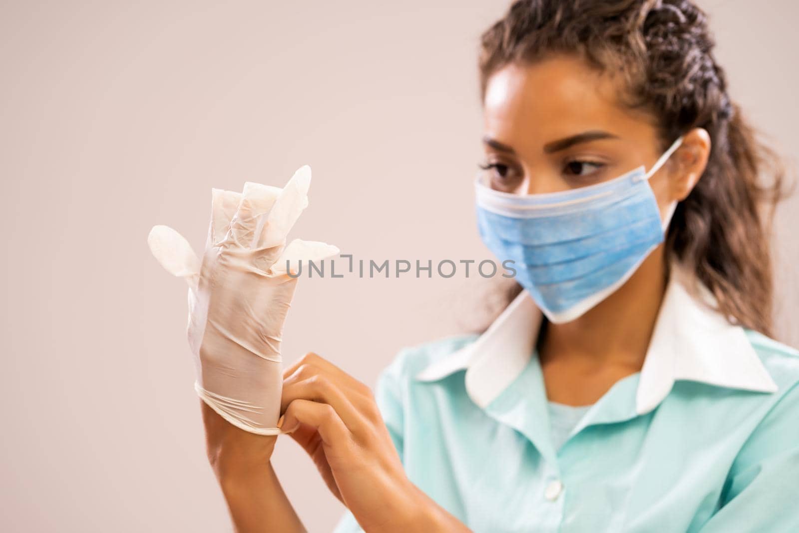 Portrait of young nurse wearing protective mask and gloves.