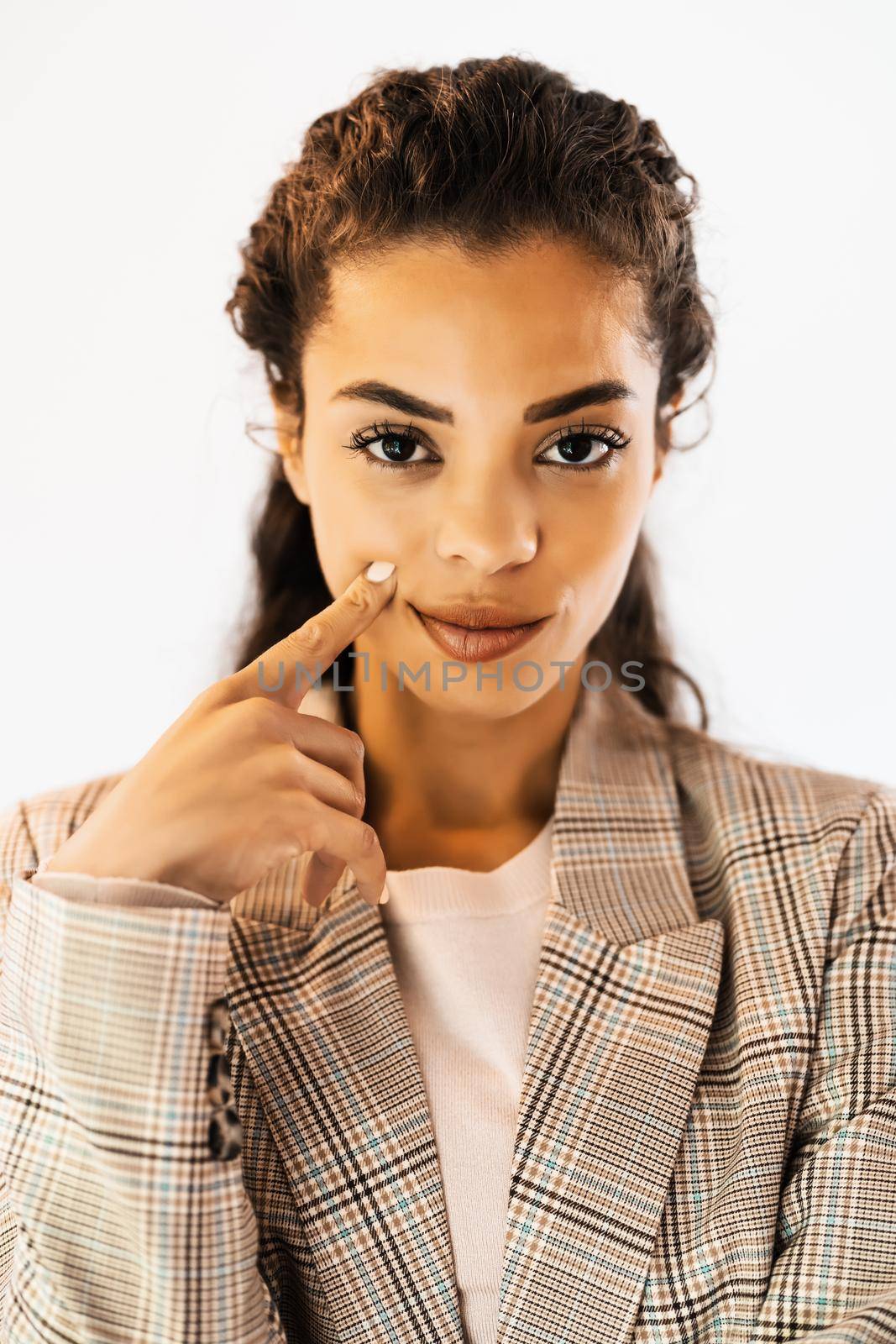 Portrait of beautiful african american woman looking at camera and thinking.