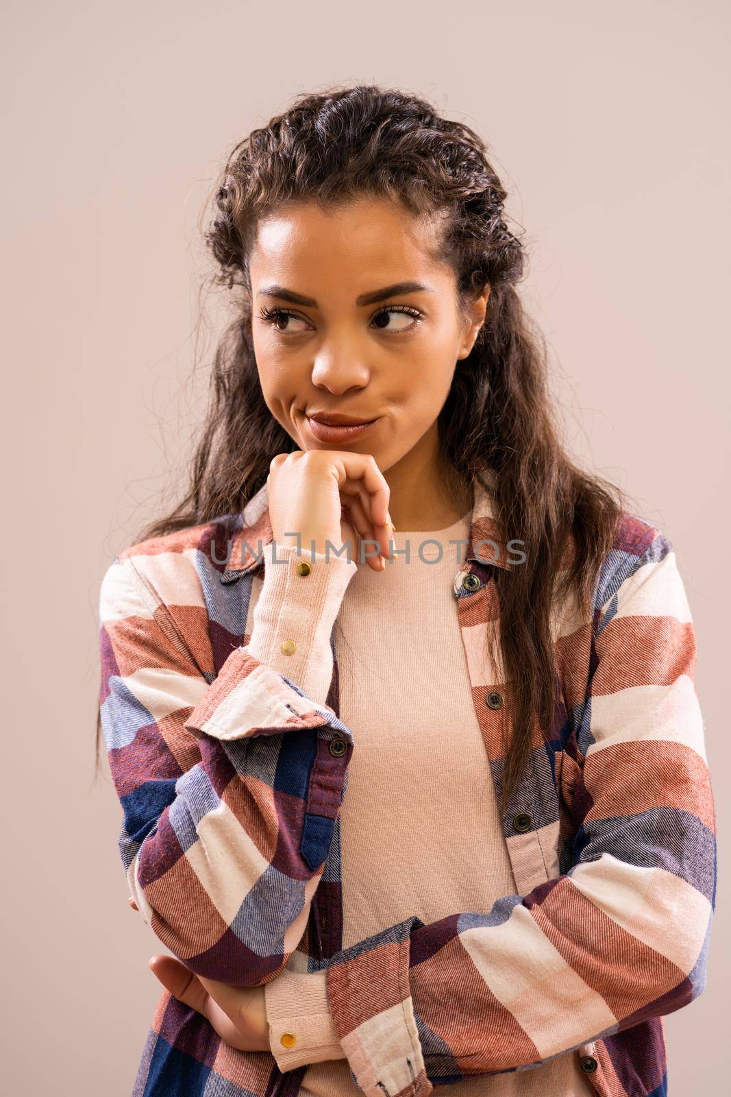 Studio shot portrait of beautiful african-american ethnicity woman who is worried and pensive.