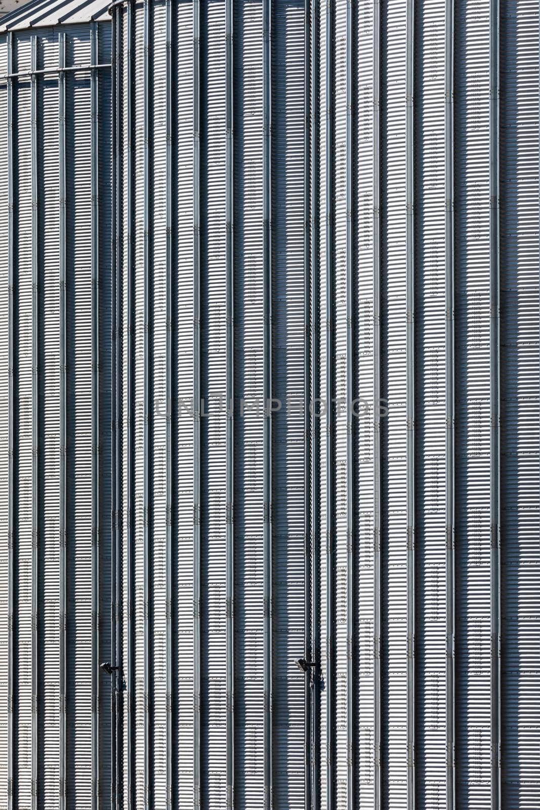 The corrugated steel sides of a storage silo at a flour mill by WittkePhotos