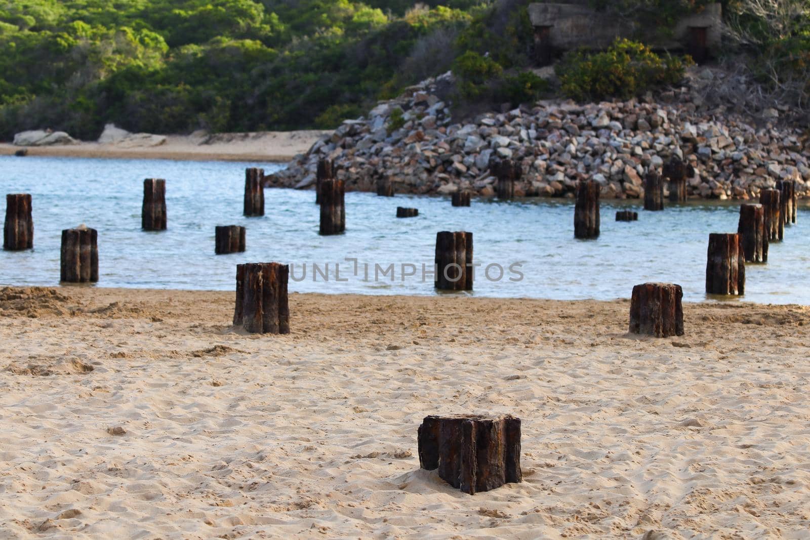 Rusted old Remnant bridge base struts over coastal riverbank, Mossel Bay, South Africa