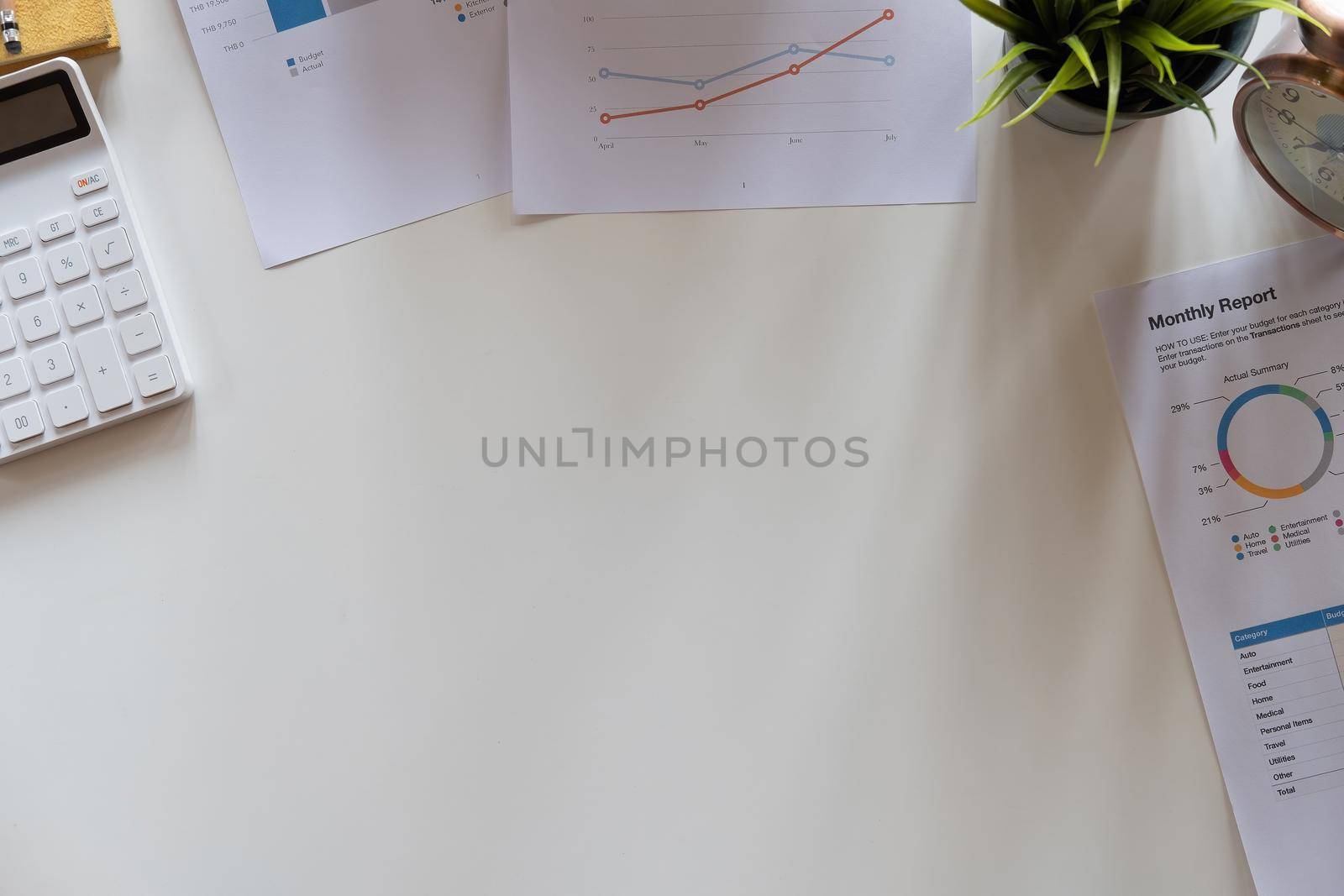 Top view hand of accountant using calculator on workplace with copy space, calculator and plant potted on white desk background, Accounting workplace concept by nateemee