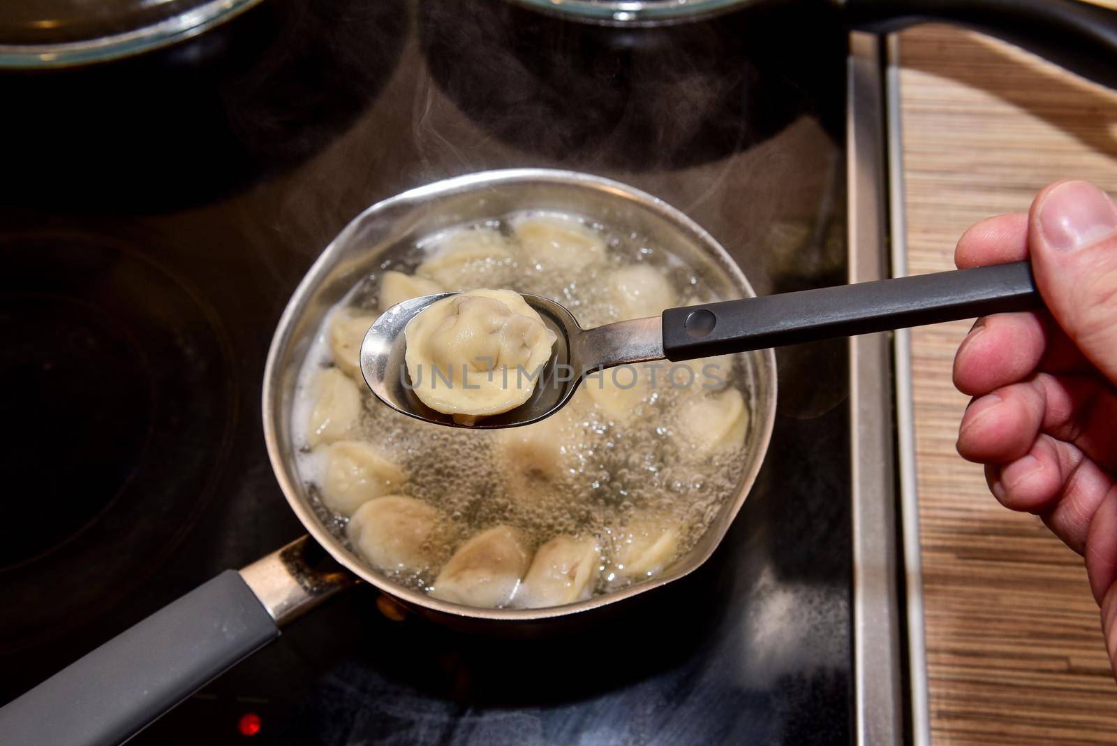 Dumplings in boiling water. Meat dumplings are boiled in a pot of boiling water.