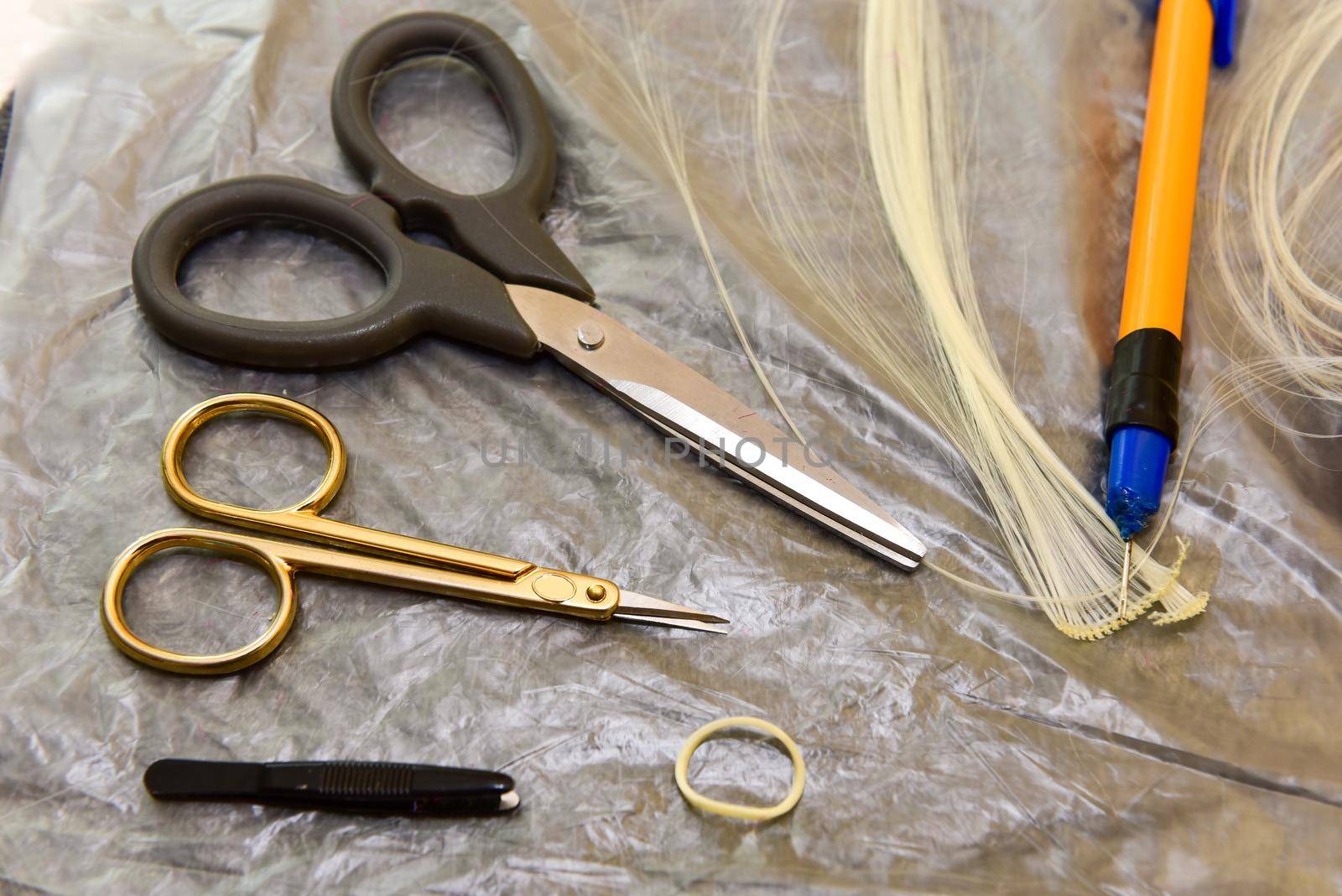 scissors and homemade tool on the table, how to make hair for a doll, hobby concept by karpovkottt