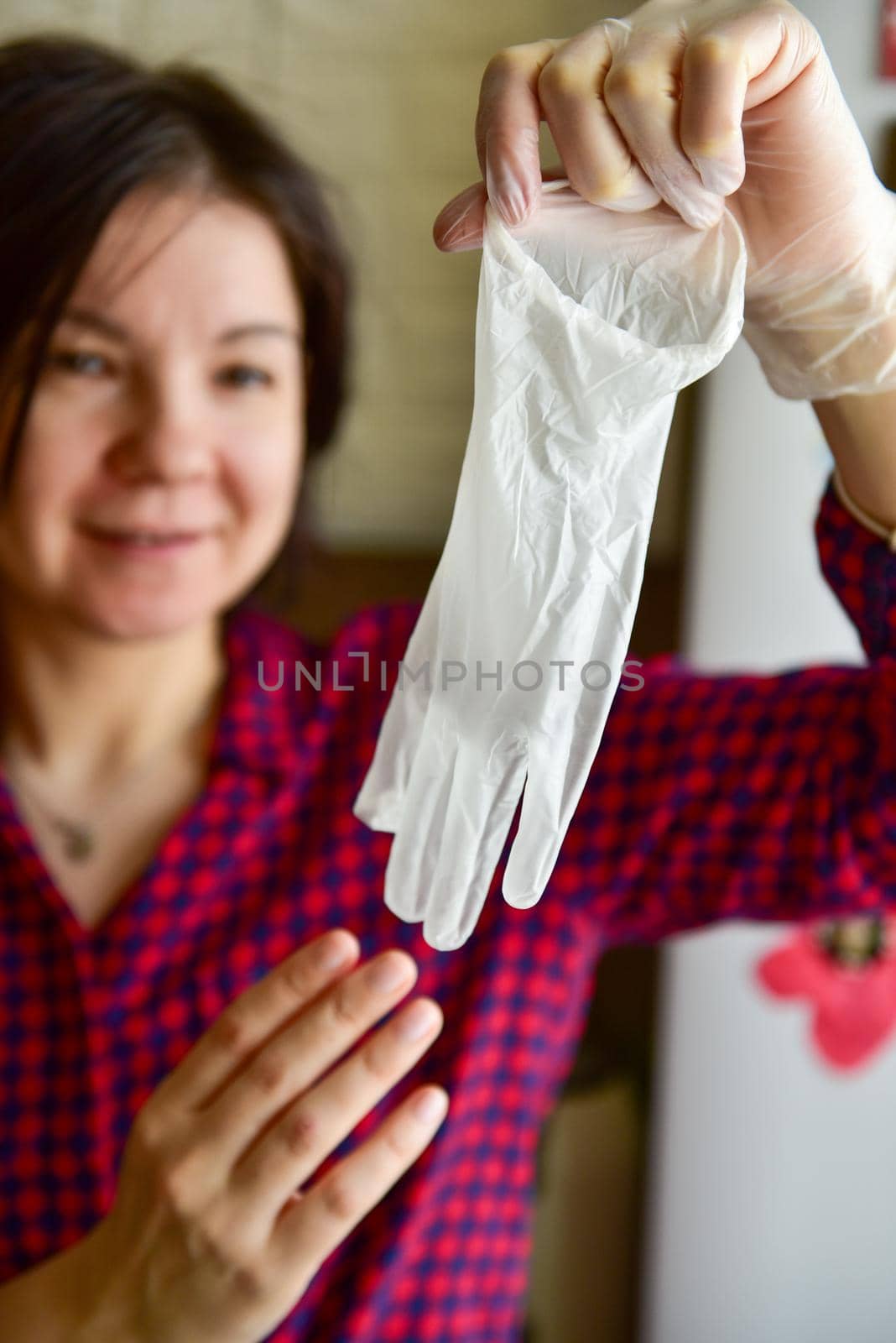 woman takes rubber gloves off her hands.