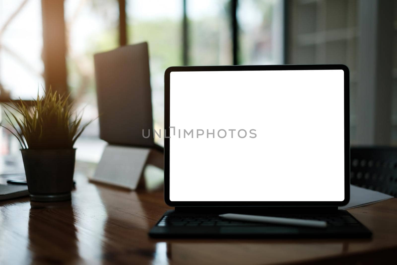 White blank screen digital tablet on modern working desk