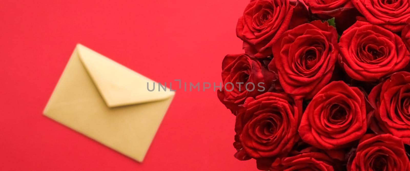 Holiday gift, flowers flatlay and happy relationship concept - Love letter and flower delivery service on Valentines Day, luxury bouquet of red roses and card envelopes on red background