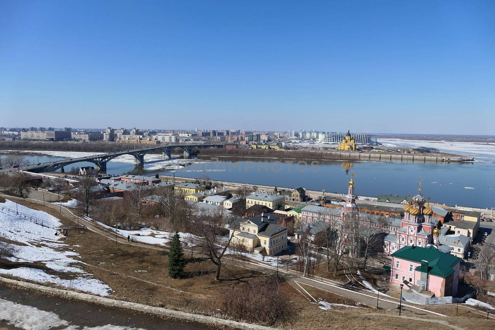A panoramic image on a bridge over a river in a port city with modern buildings and churches. by Olga26