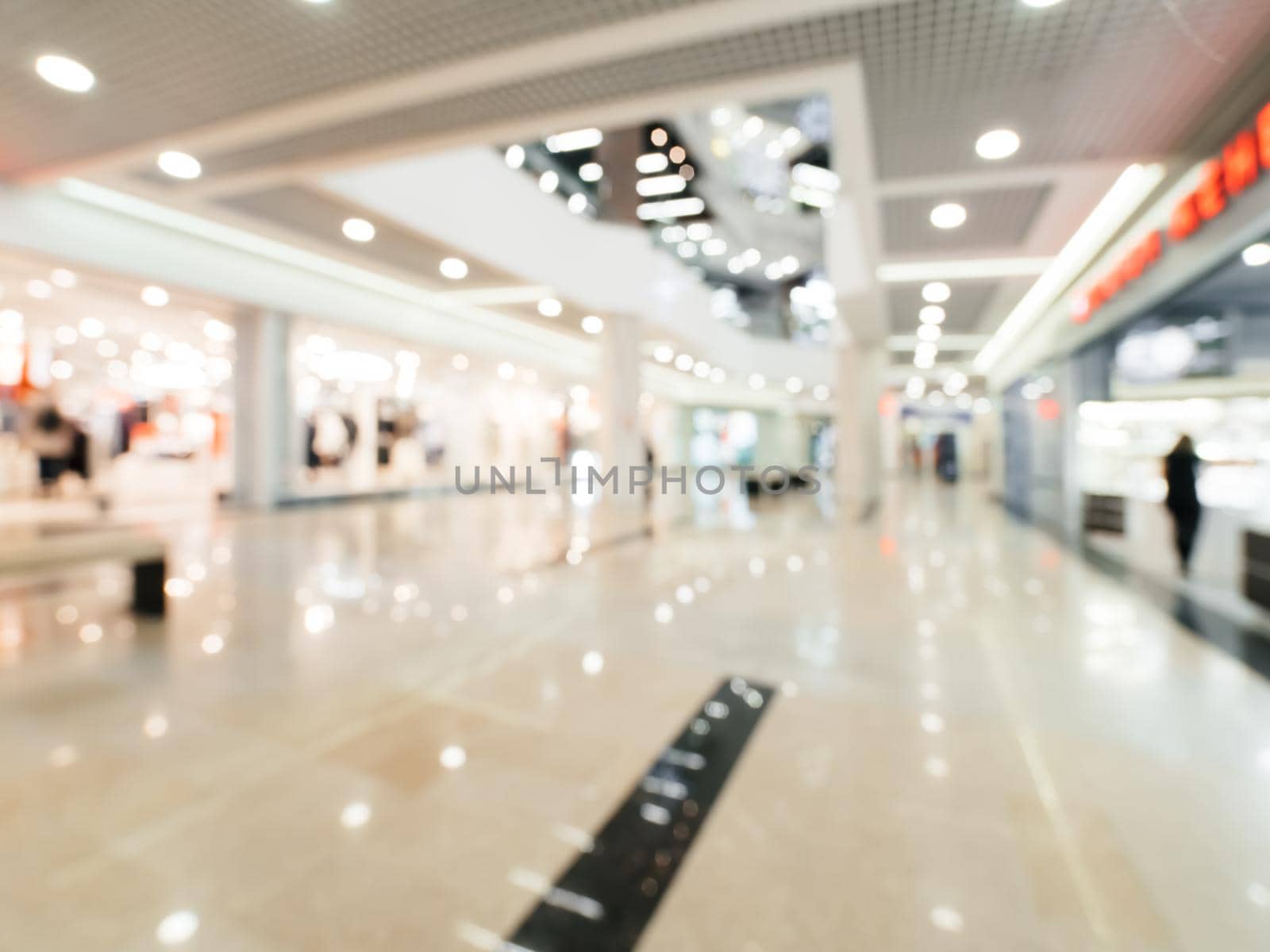 Shopping mall blur background with bokeh. Blurred hall of shopping mall as background.
