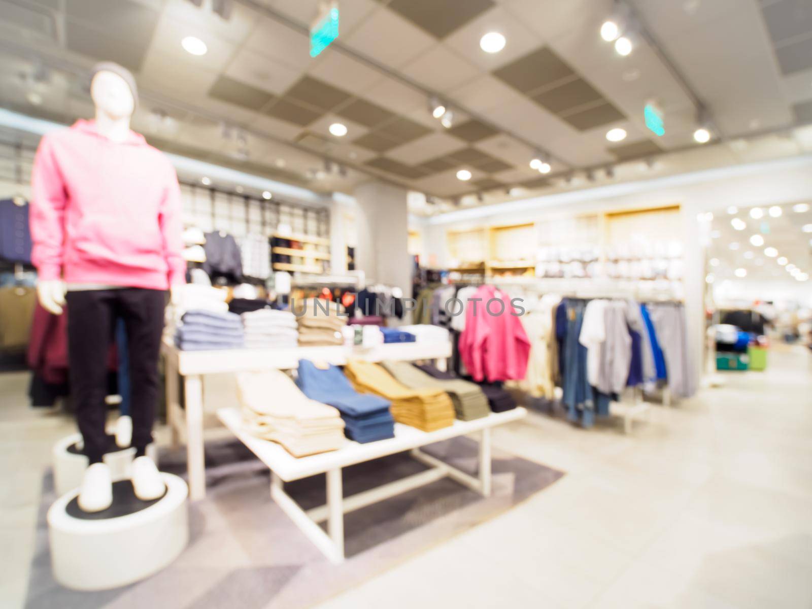 Blur image of clothes and mannequins in clothing store as background
