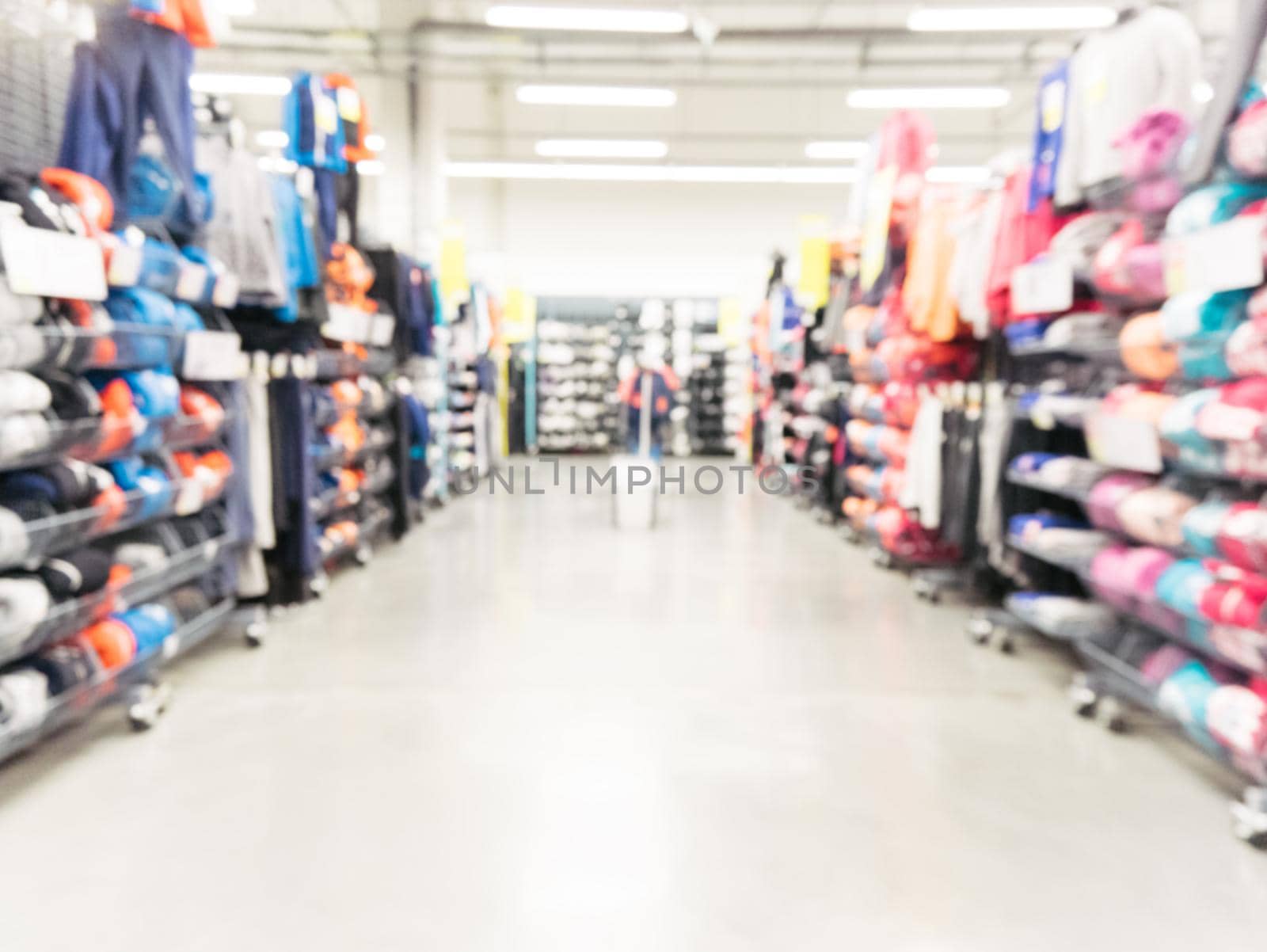 Abstract blurred sport and travel hypermarket aisle with colorful shelves as background