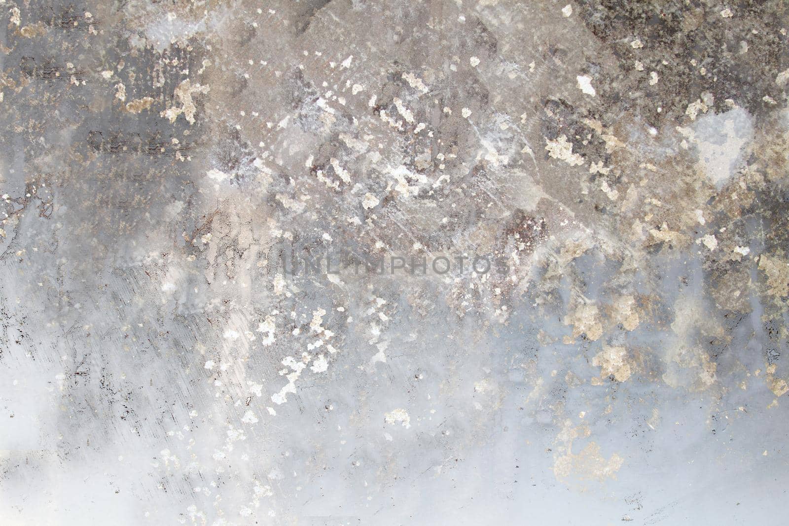 Gray concrete wall with a damaged and rough surface close-up.Texture or background
