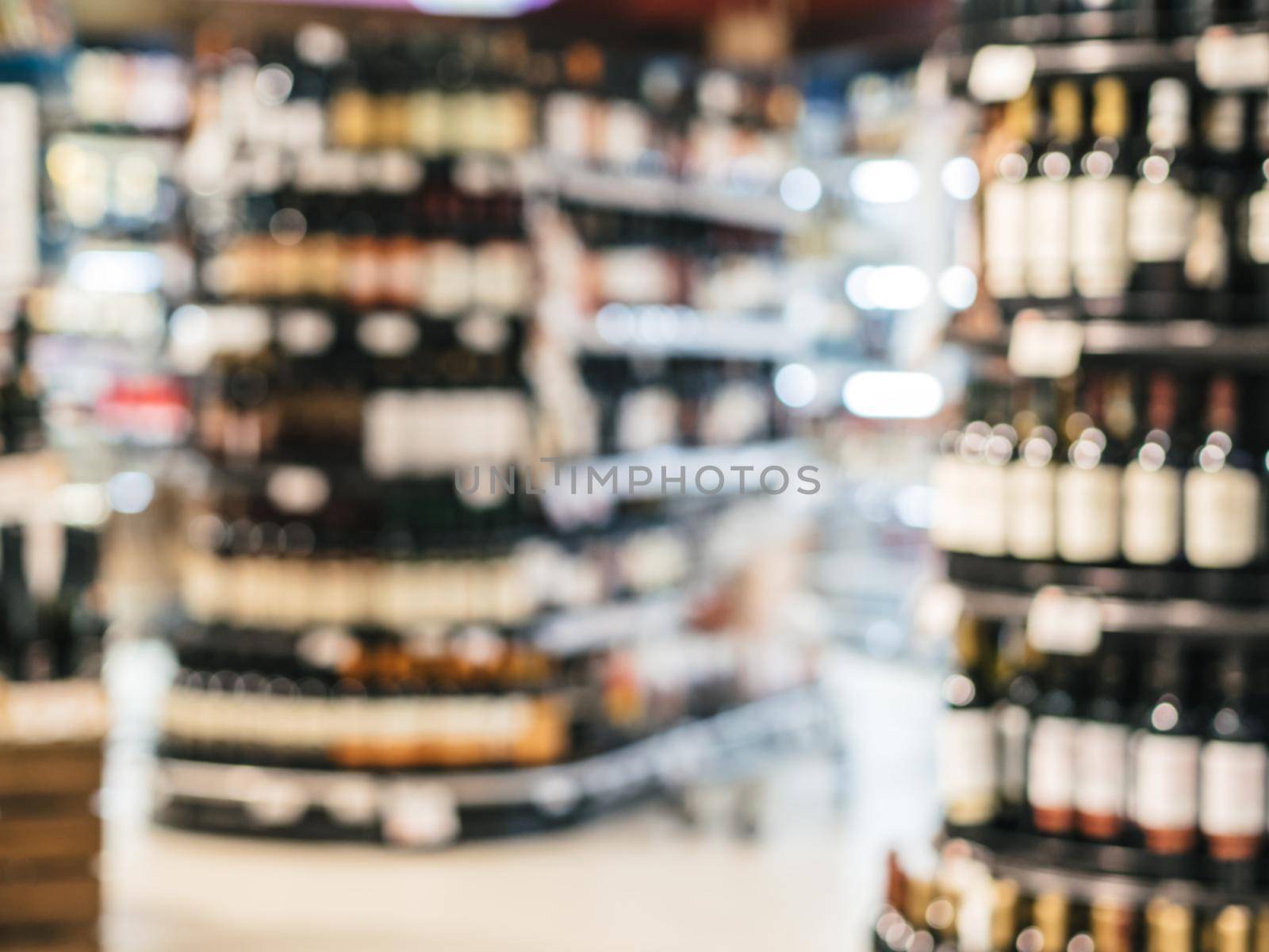 Abstract blurred supermarket colorful shelves with alcohol, wine bottles as background