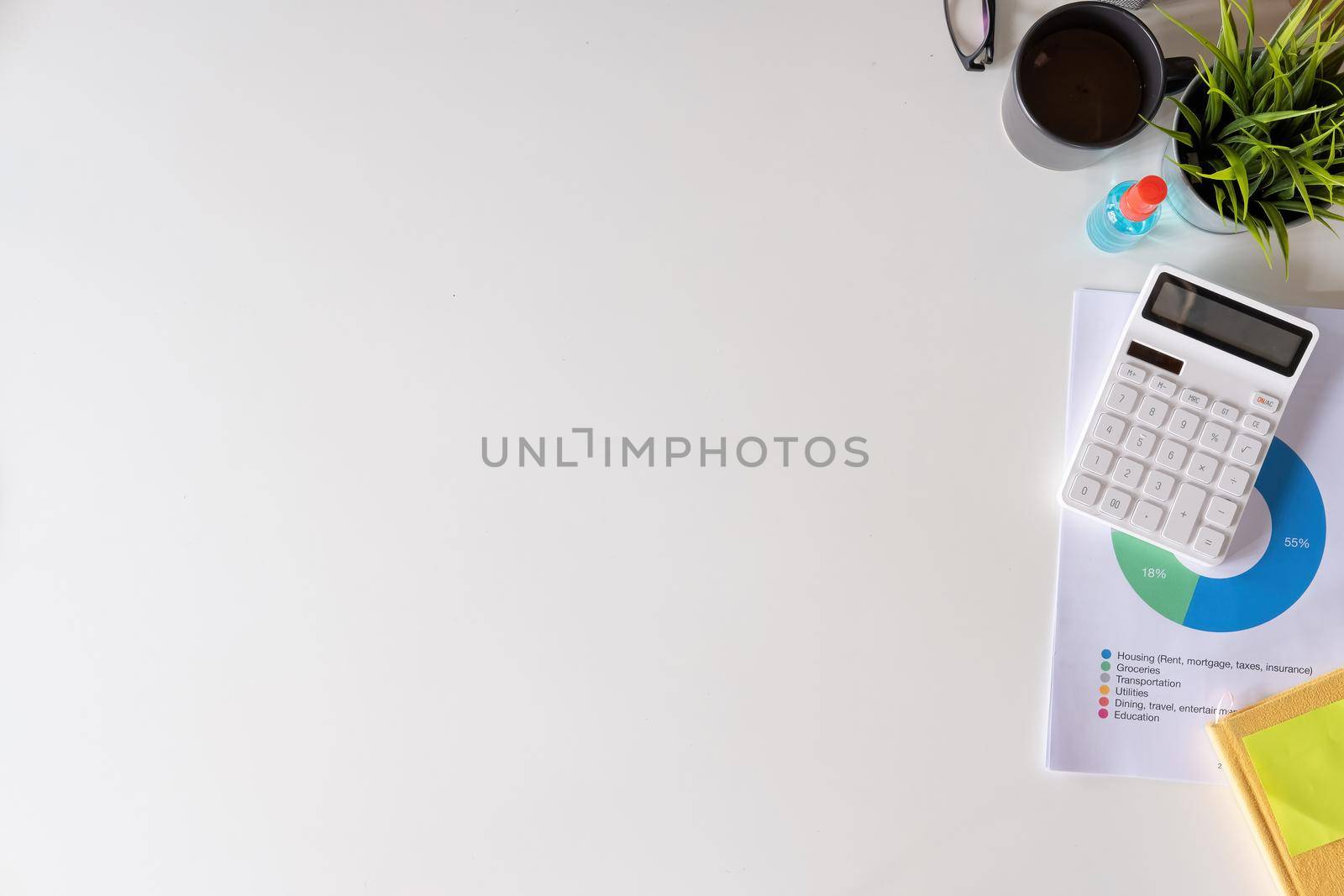 Hand sanitizer spray on business financial work place. Flat lay with laptop computer and white workspace background with copy space. Top view.