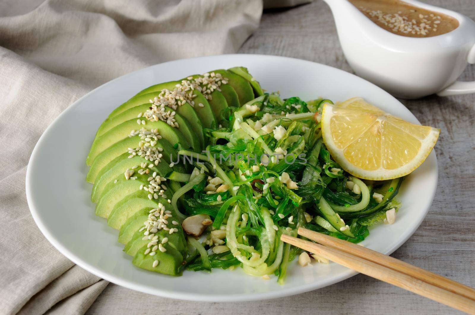 Chukka salad, cucumber noodles with avocado and peanut brown sauce in sauceboat