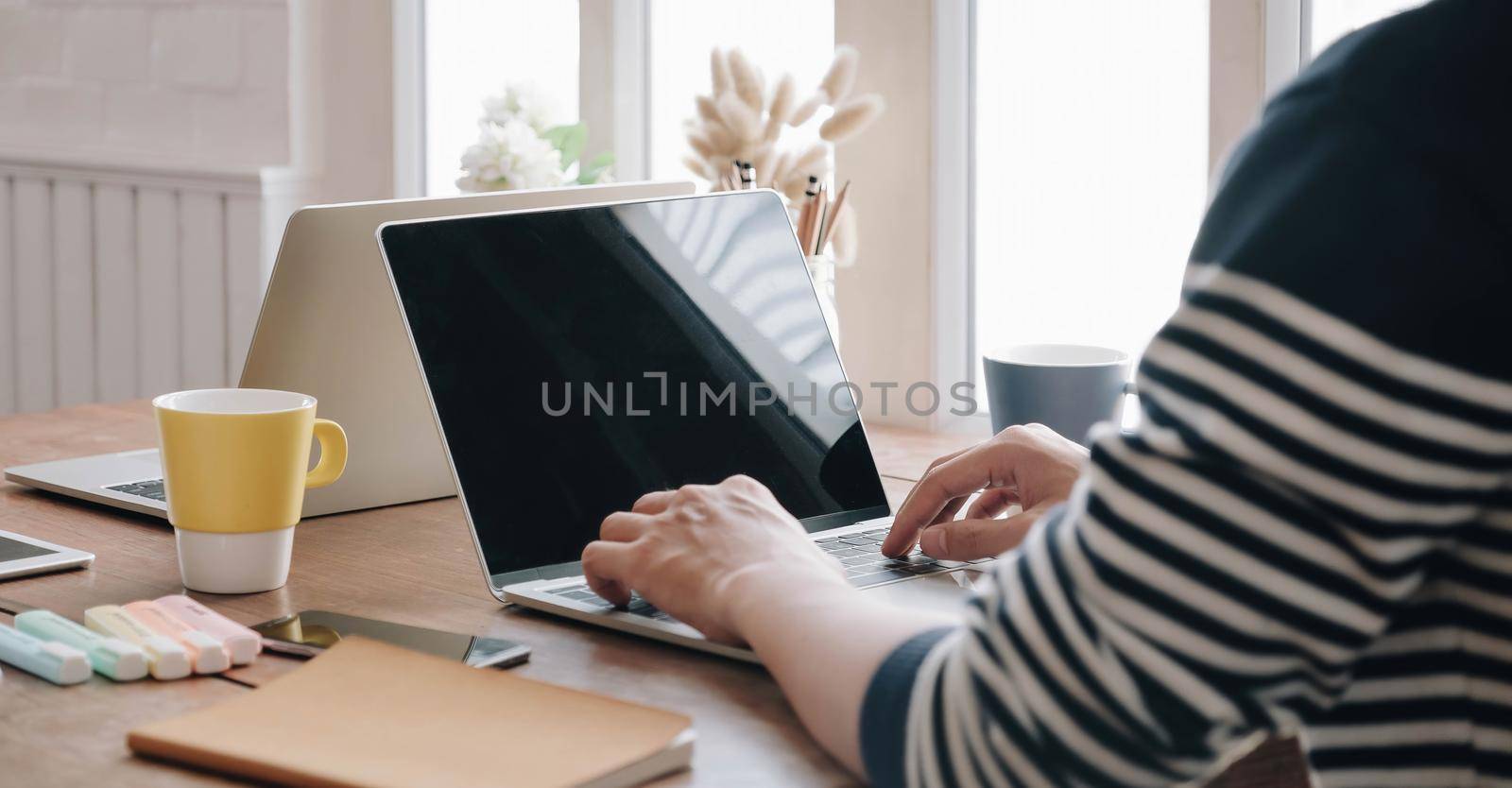 Close-up image of young professional male manager using laptop at he office, businessman working from home.
