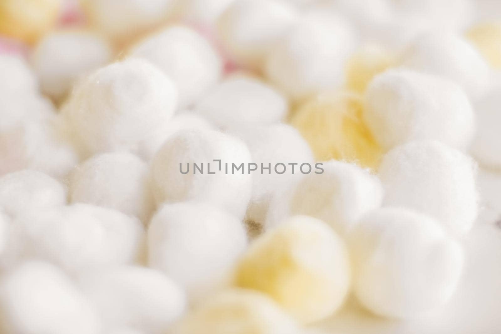 Cosmetology, branding and cleanliness concept - Organic cotton balls background for morning routine, spa cosmetics, hygiene and natural skincare beauty brand product as healthcare and medical design