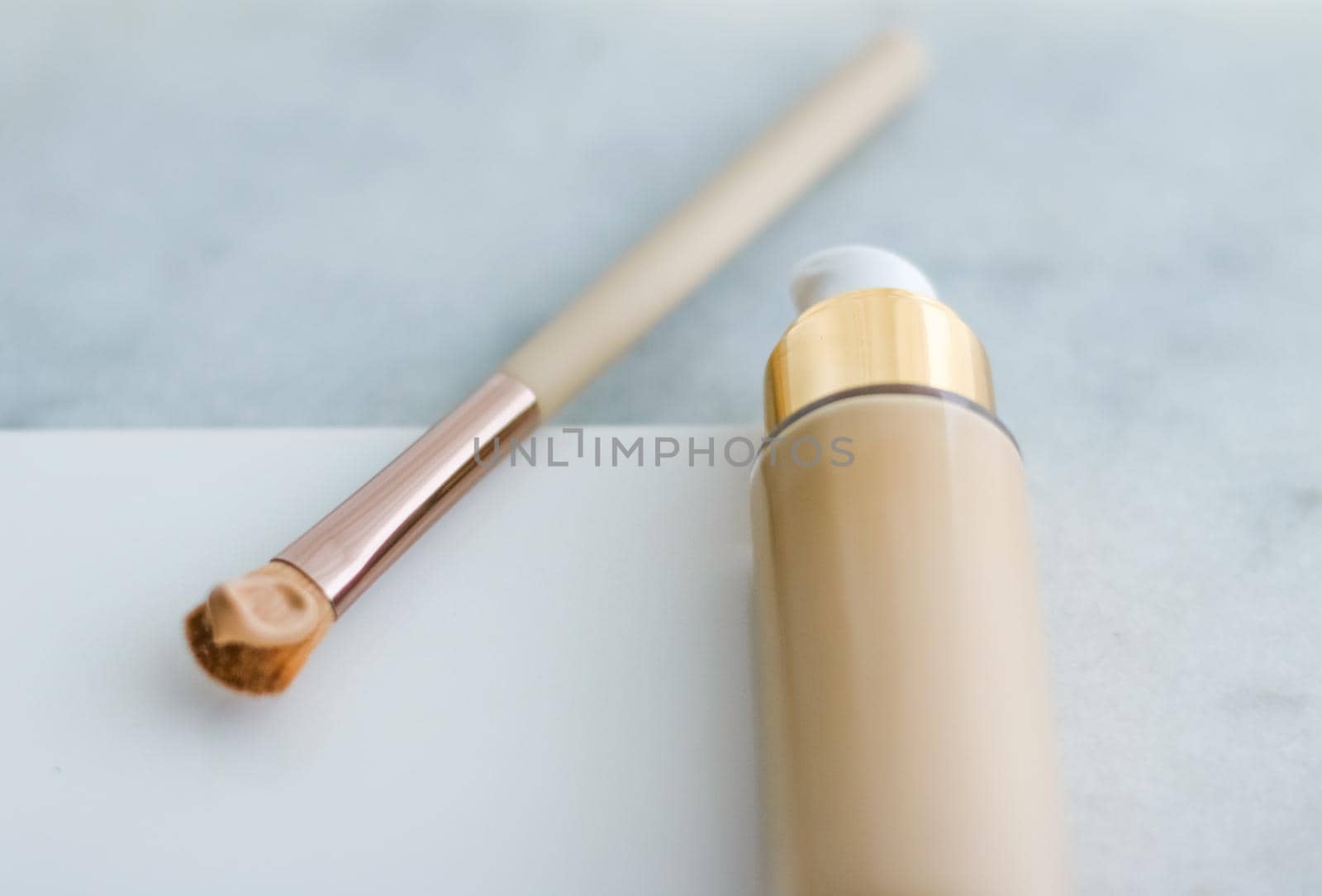 Cosmetic branding, glamour and skincare concept - Makeup foundation bottle and contouring brush on marble, make-up concealer bb cream as cosmetics product for luxury beauty brand holiday design