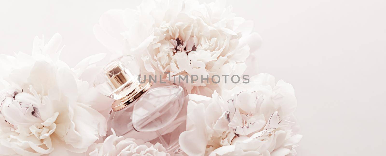 Fragrance bottle as luxury perfume product on background of peony flowers, parfum ad and beauty branding by Anneleven