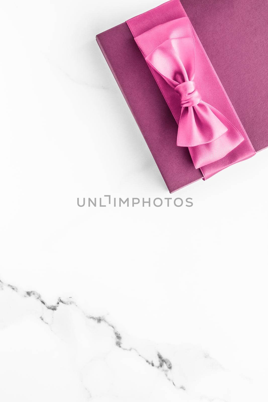 Birthday, wedding and girly branding concept - Pink gift box with silk bow on marble background, girl baby shower present and glamour fashion gift for luxury beauty brand, holiday flatlay art design