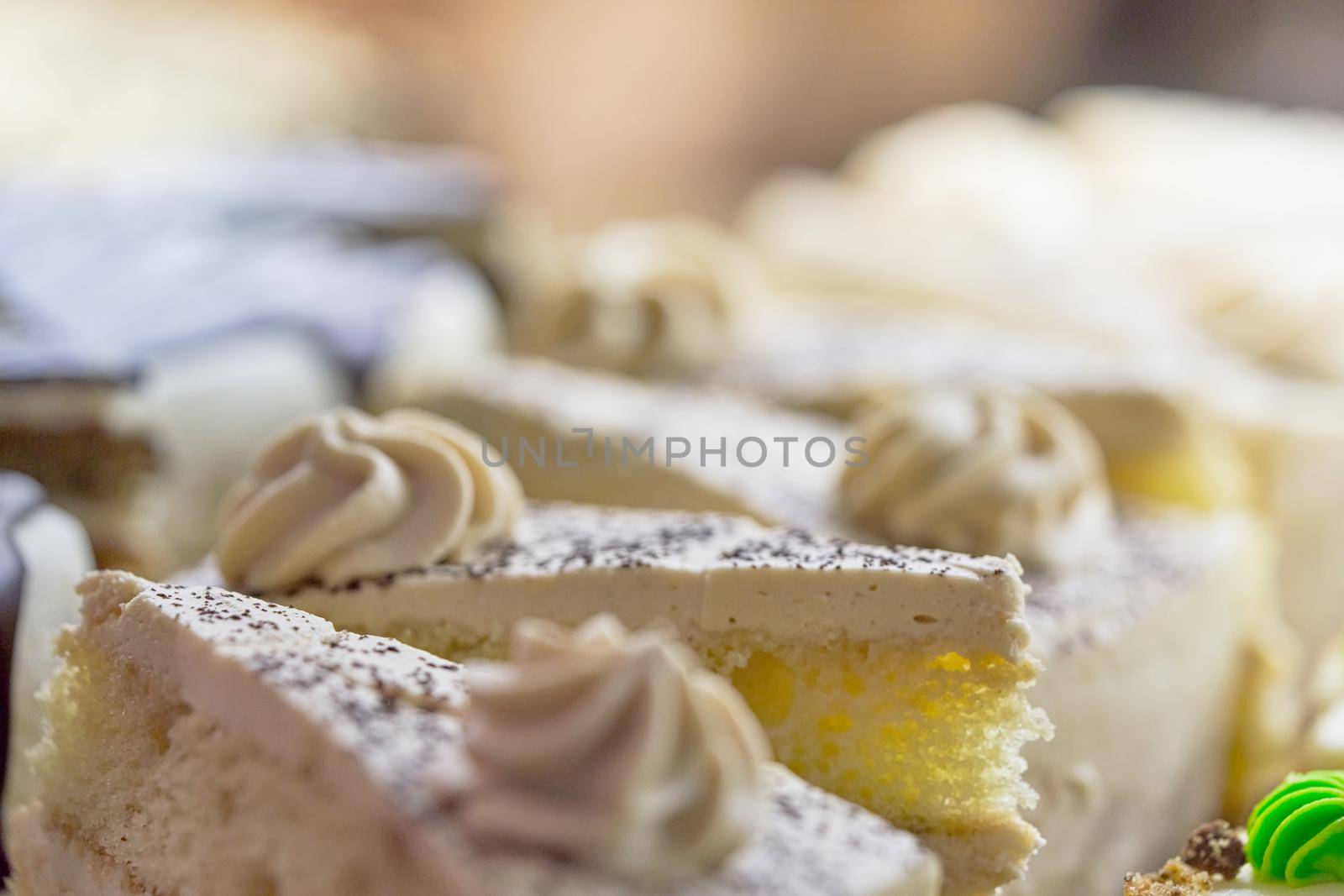 Sponge cake with marshmallow white cream close up. Light shot blur