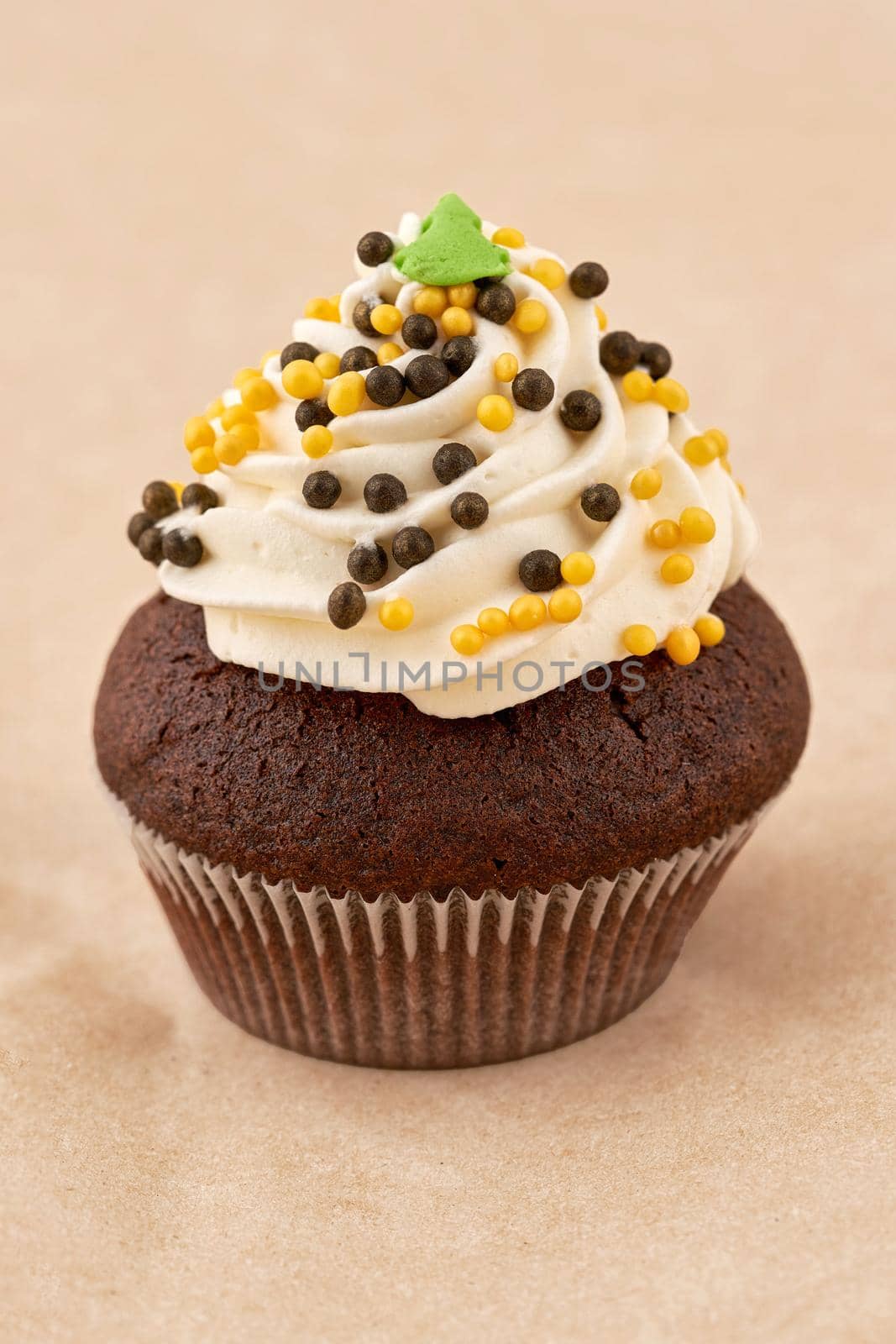 Chocolate muffin cake with marshmallow cream. Close up on light background, vertical frame