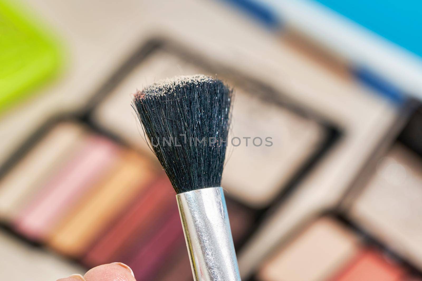 Open Box of Multicolored Eyeshadow with Makeup Brush