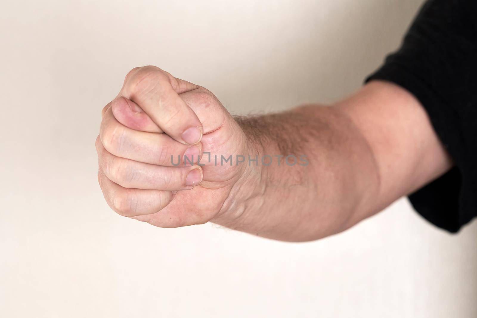 Fingers folded in a fig outstretched towards the camera