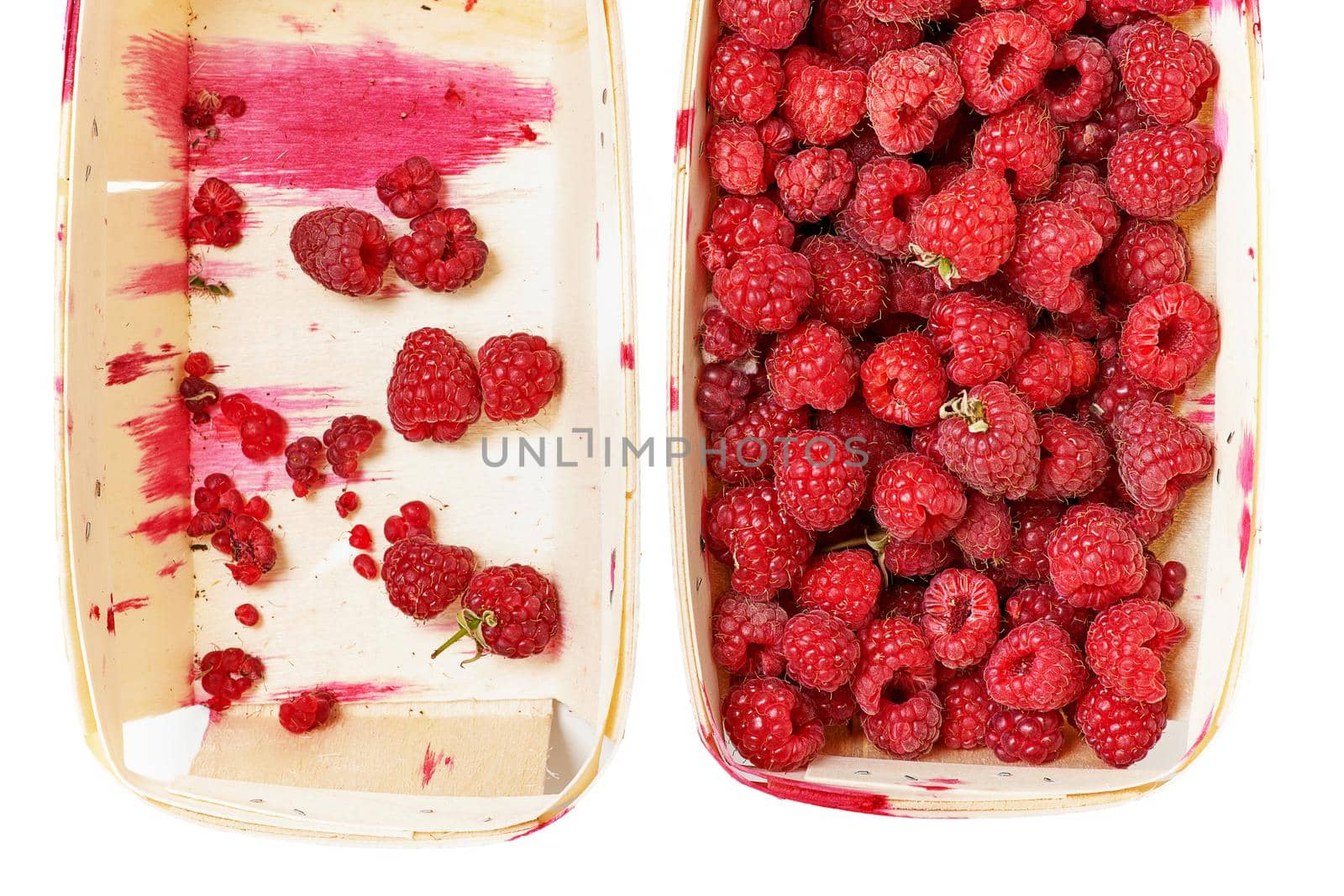 A full and empty box of fresh red raspberries. Top view close up