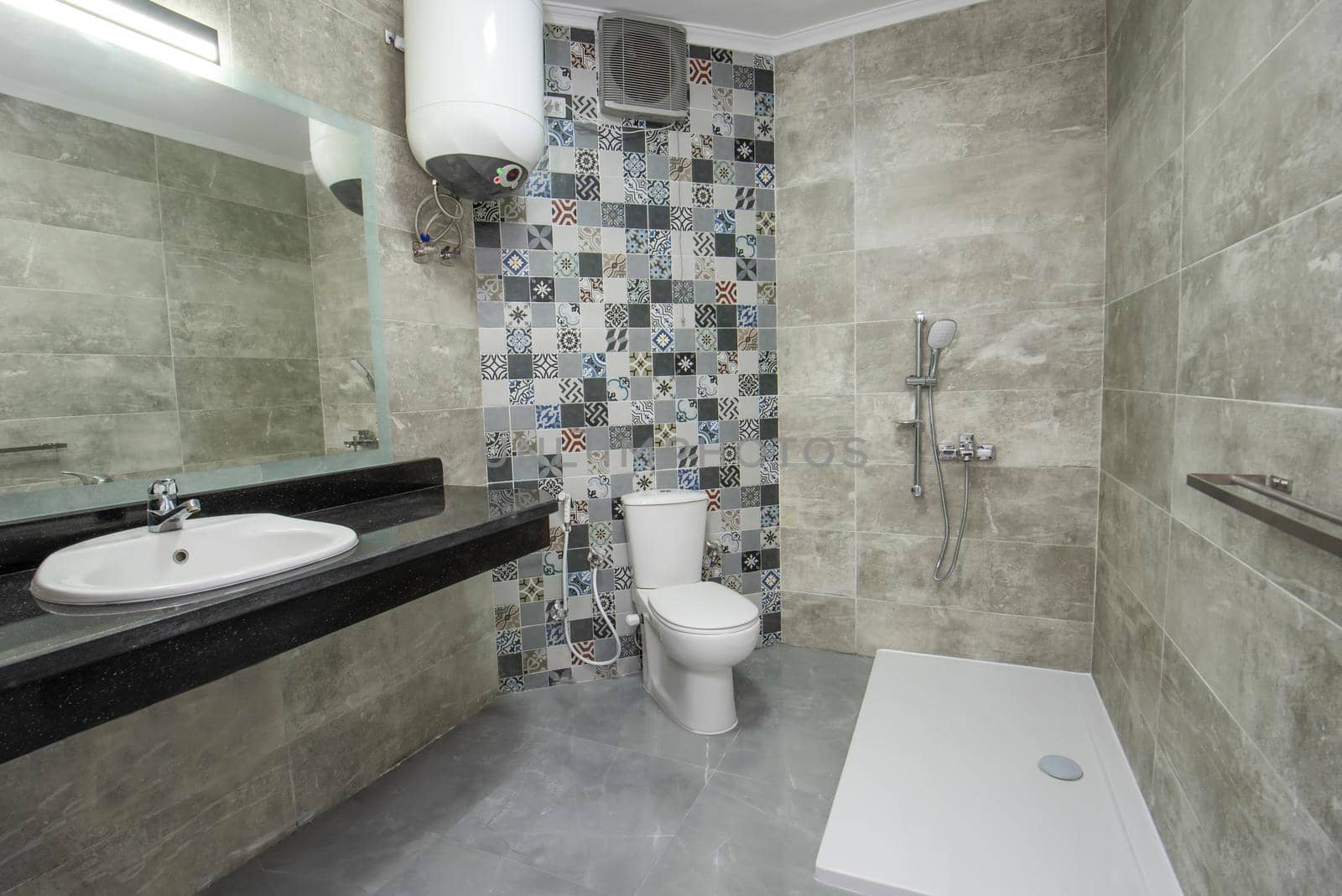 Interior design of a luxury show home bathroom with disabled access shower wet room and sink