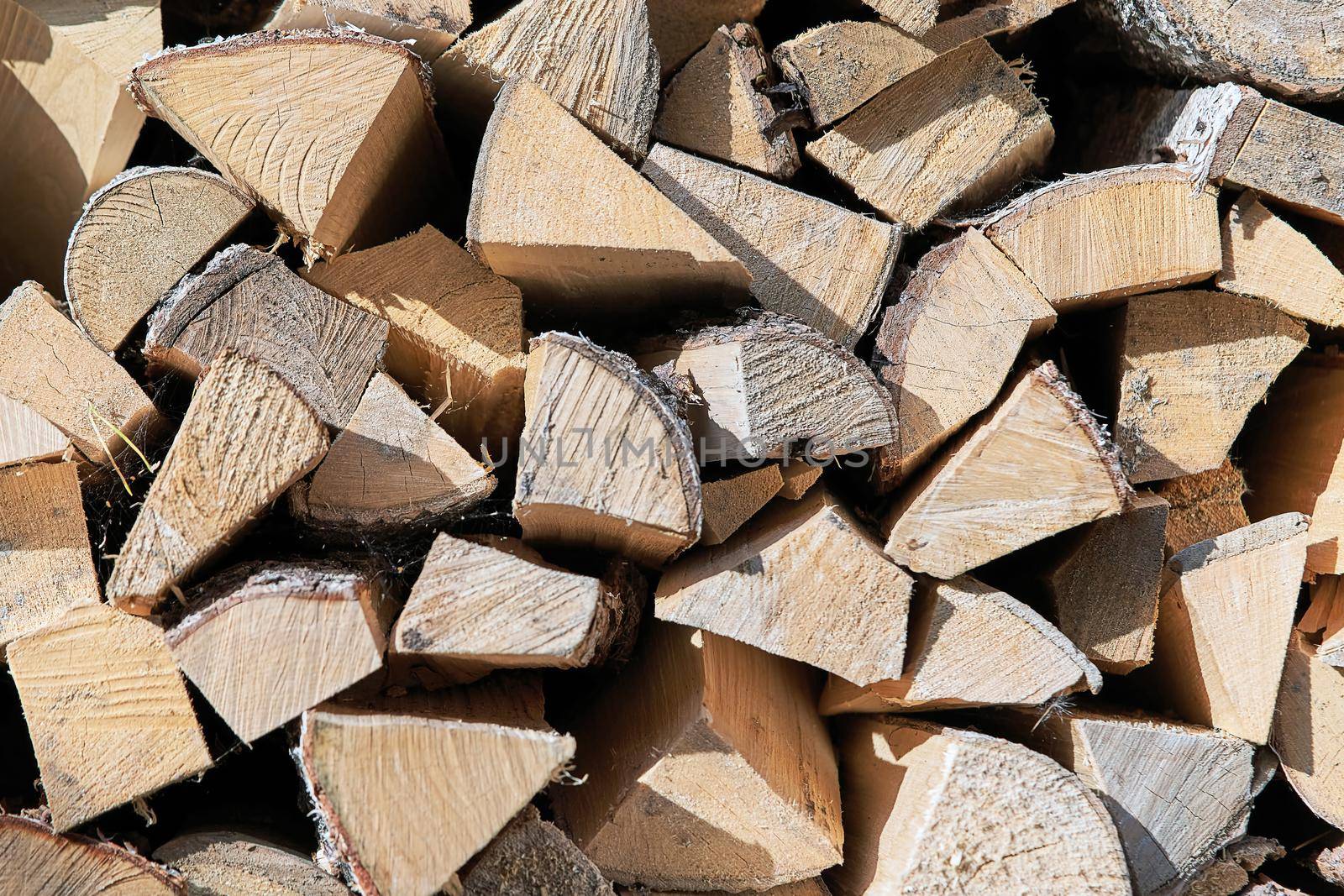 View of the woodpile, the ends of the pieces of wood. Background and texture