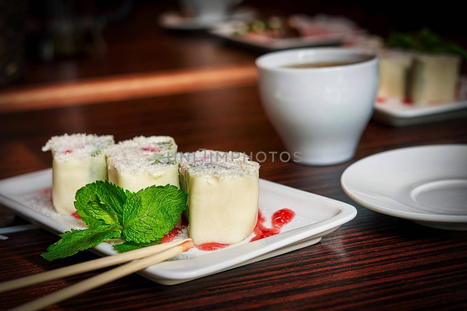 White dish with japanese fruit dessert minari and green mint leaf on wooden table background