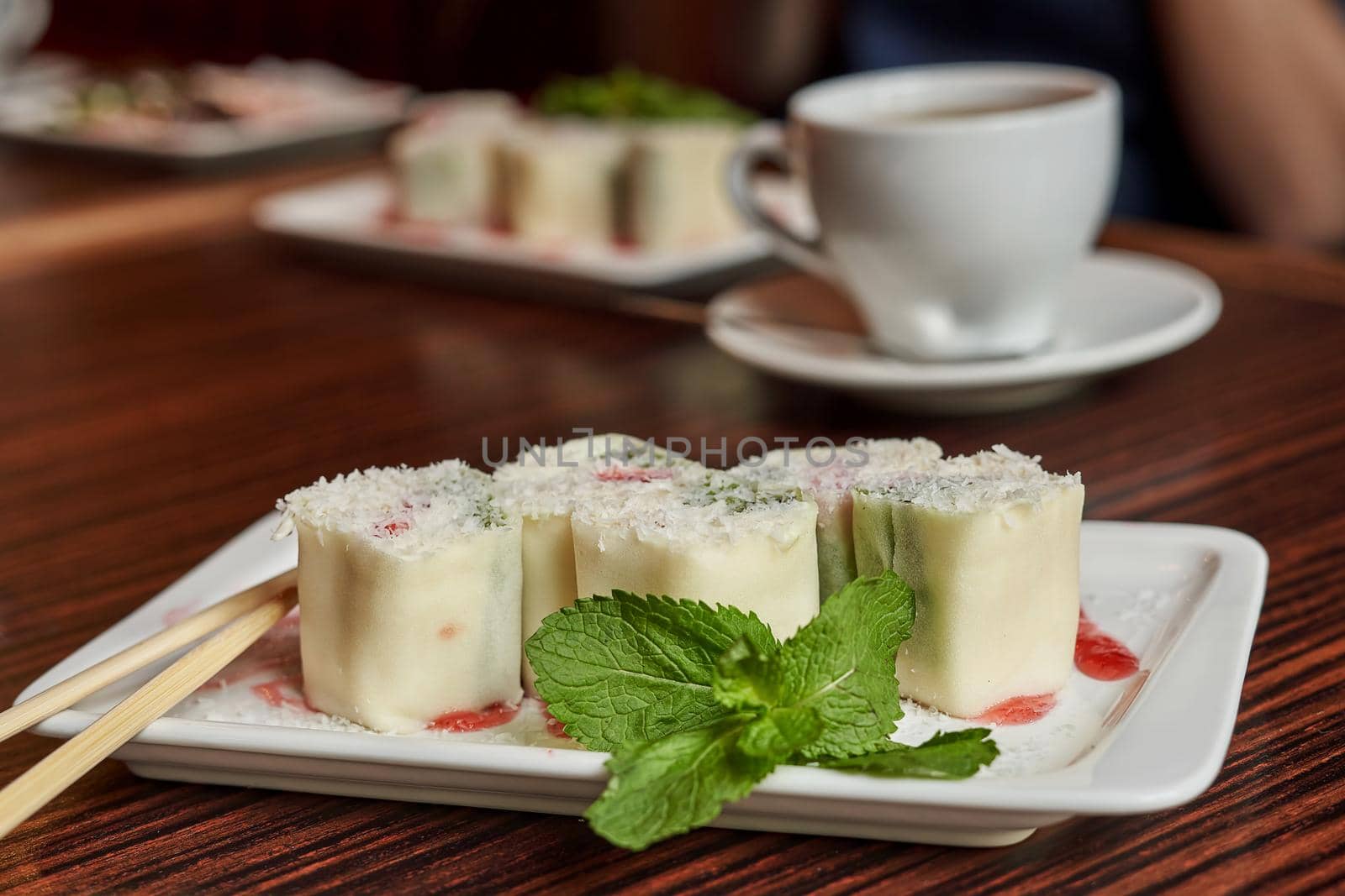 White dish with japanese fruit dessert minari and green mint leaf on wooden table background