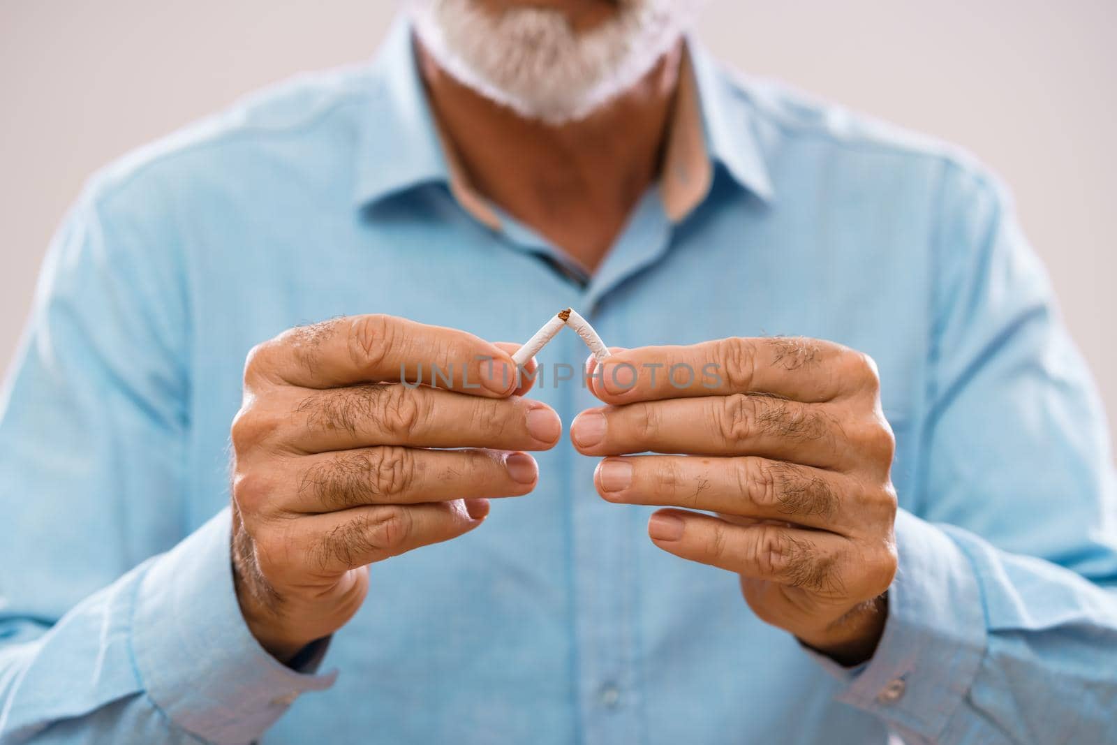 Serious senior man is decided to quit smoking.