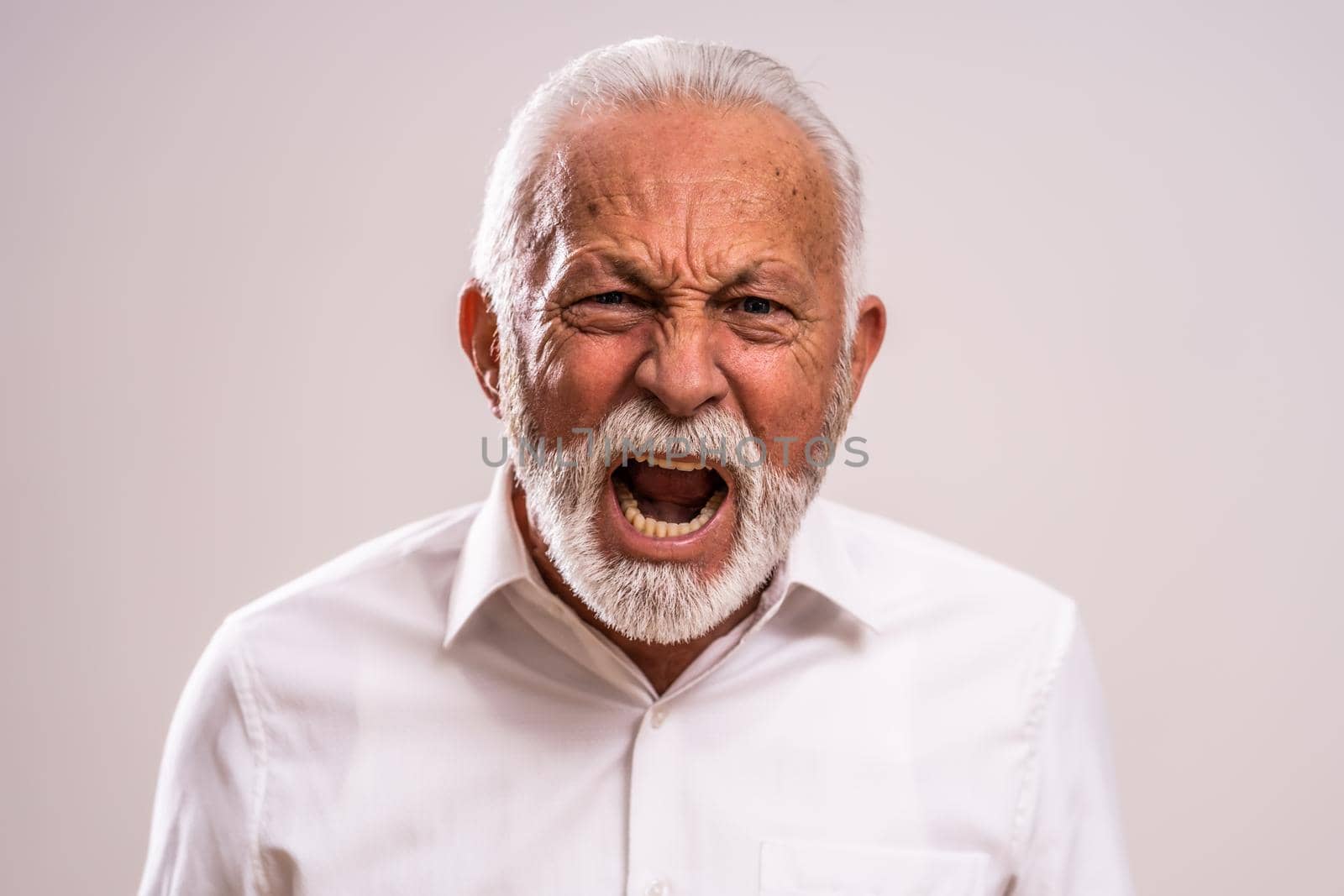 Portrait of furious senior man who is screaming.