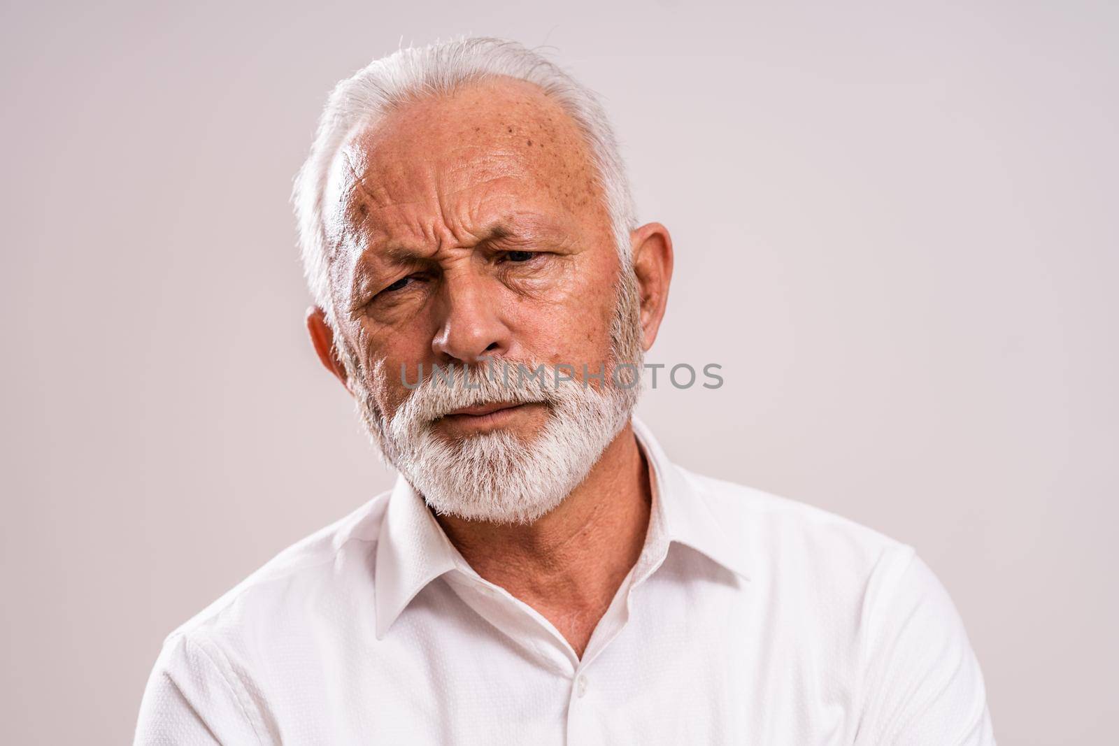 Portrait of bored and depressed senior man.